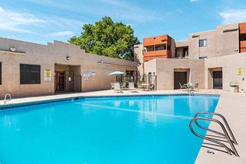 a large swimming pool in front of a building